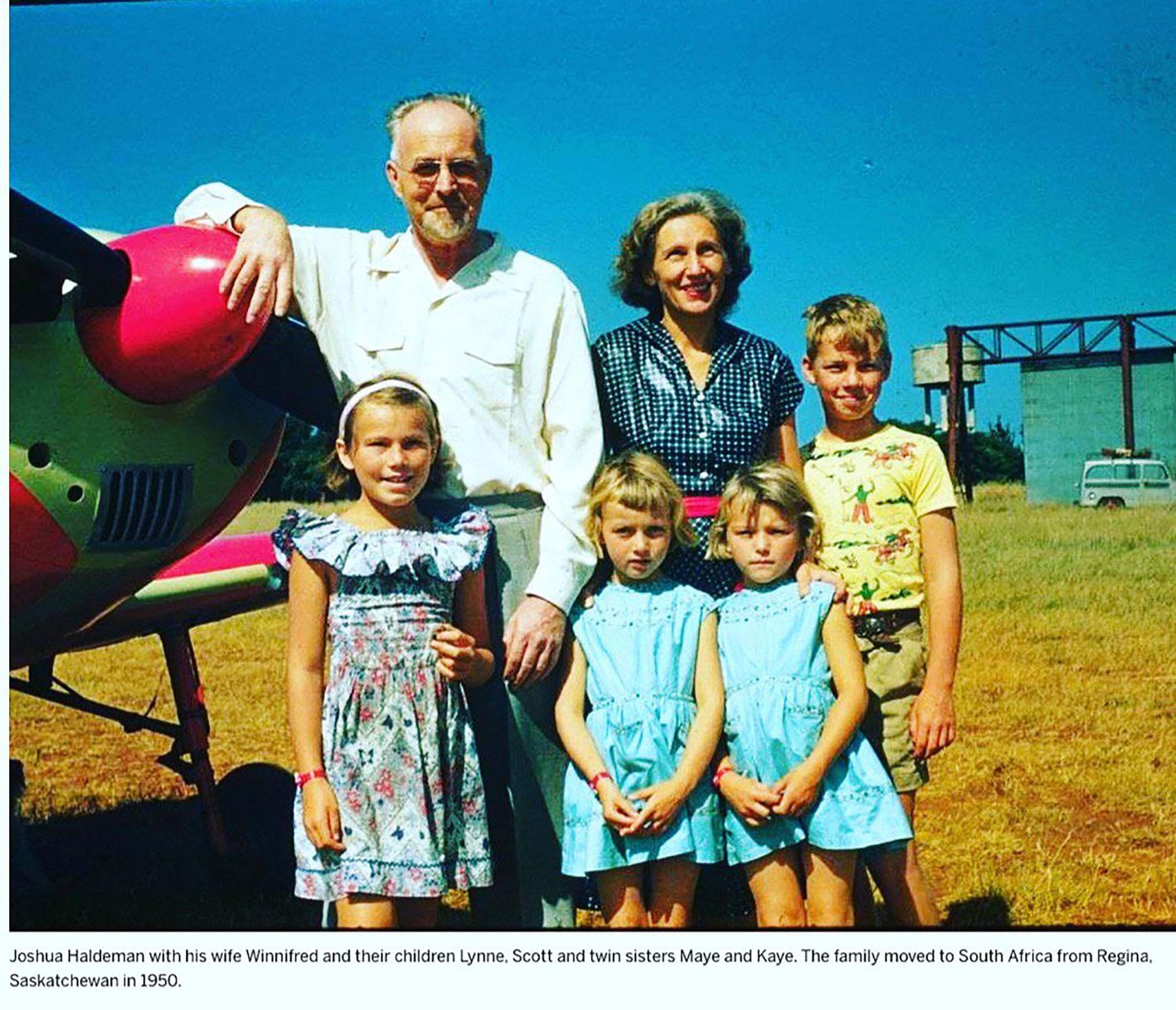 Joshua and Winnifred Haldeman standing with their children beside an aircraft.